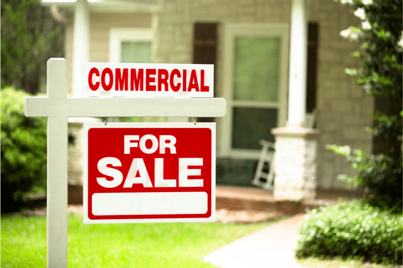 A for sale sign on a residential house looking at corporate property return warnings A for sale sign on a residential house looking at corporate property return warnings
